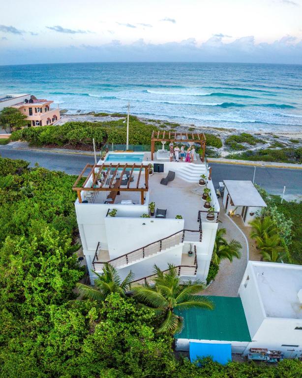 Oceanfront home at Icaco Island Village, surrounded by lush greenery, offering a serene adults-only retreat in Isla Mujeres.
