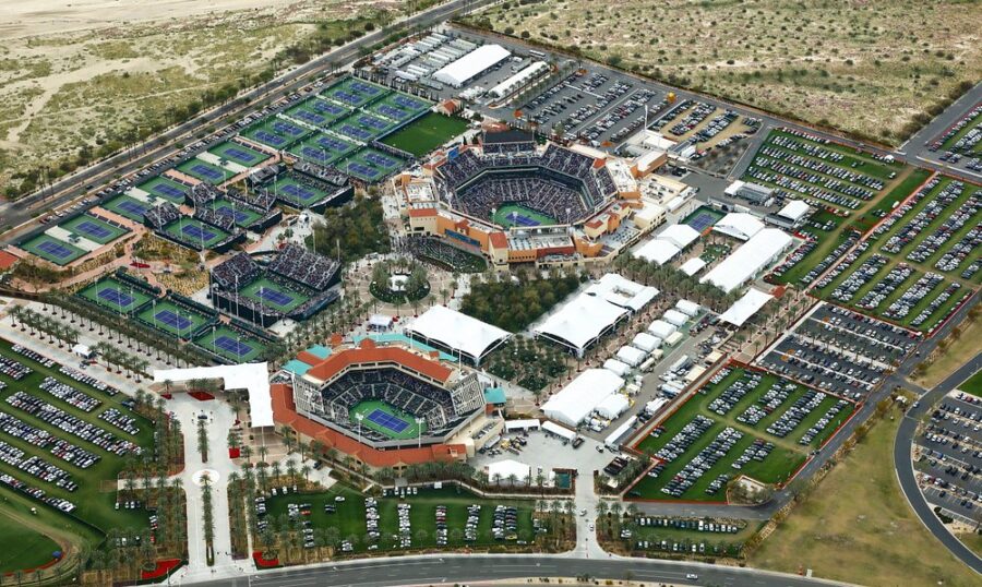 Aerial view of the Indian Wells Tennis Garden complex in Las Vegas, showcasing multiple tennis courts and surrounding landscape.
