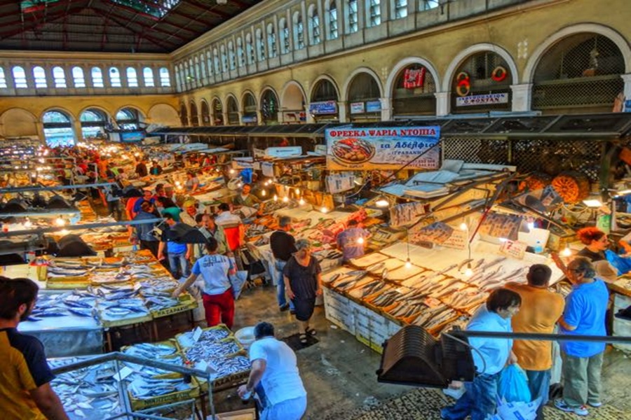 Bustling Greek fish market scene with colorful seafood and vibrant community interactions.