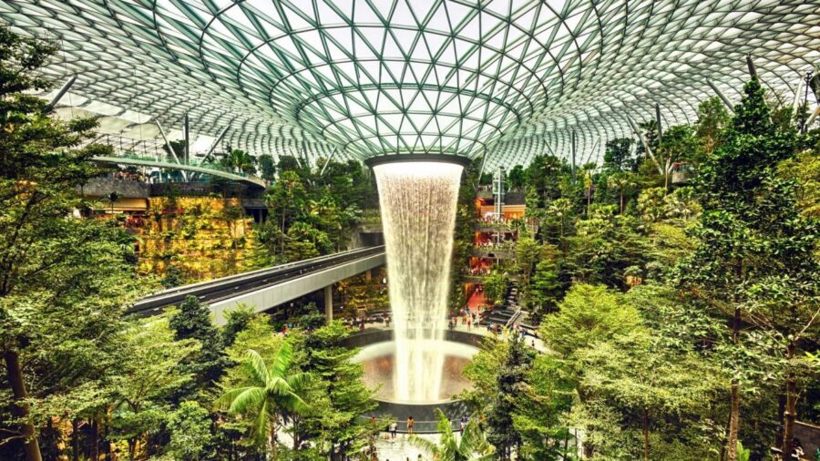 Indoor waterfall garden at Changi Airport blends nature with modern architecture.