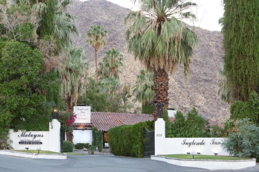 Entrance to Ingleside Estate Hotel & Bungalows in Palm Springs, California, featuring lush landscaping and elegant architecture.
