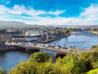 Scenic cityscape of Inverness, Scotland, highlighting the River Ness, charming streets, and surrounding natural landscapes.