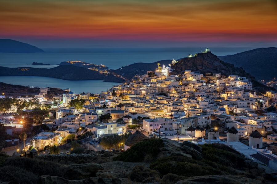 Evening view of the Chora of Ios in the Cyclades, Greece, beautifully lit after sunset, showcasing its charming architecture