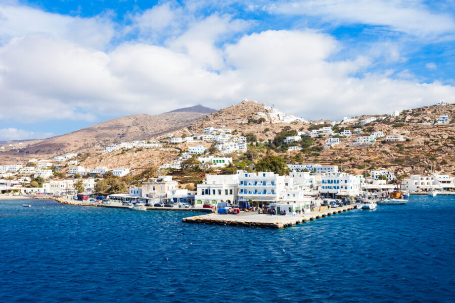 Scenic view of Ios Island, Greece, showcasing its white-washed buildings and vibrant blue sea under a clear sky