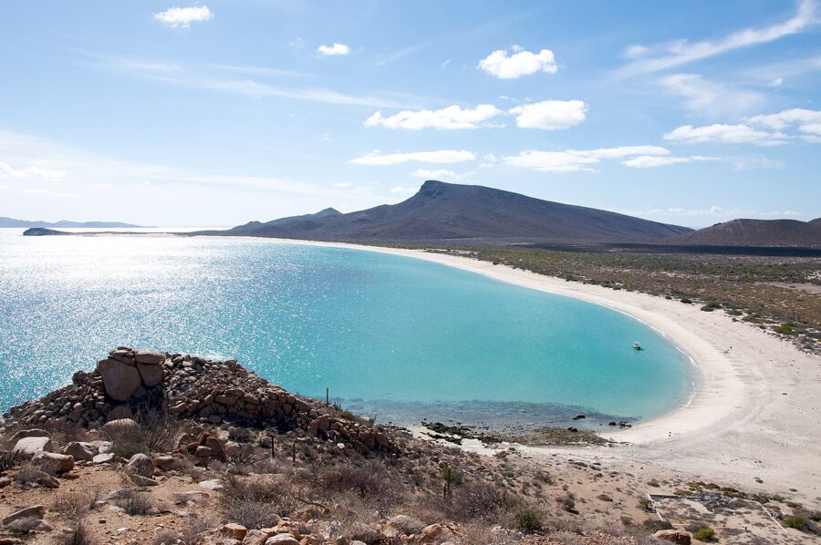 Scenic view of Isla Espíritu Santo featuring a vast body of water and a sandy beach in La Paz, Mexico.