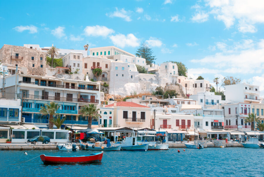 Tranquil waters at the port of Naxos Island, framed by boats and picturesque coastal landscapes.