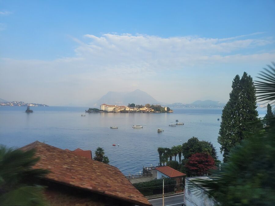 Scenic lake view from a balcony in Isola Bella, Borromean Islands, highlighting tranquil waters and natural beauty.