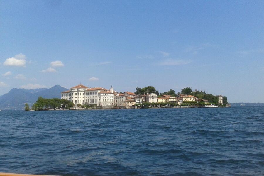 Scenic view of Isola Bella, featuring its architectural structures set against a backdrop of vibrant greenery and water.