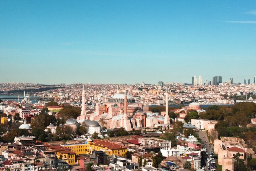 Panoramic view of Istanbul: Hagia Sophia, Bosphorus, historical sites, modern skyline, vibrant cityscape.