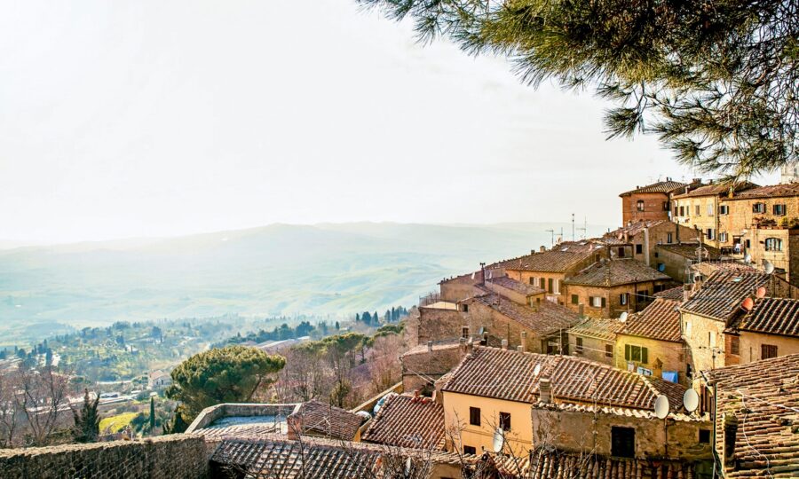 Charming Italian hillside village with stone buildings, terracotta roofs, and picturesque landscape.