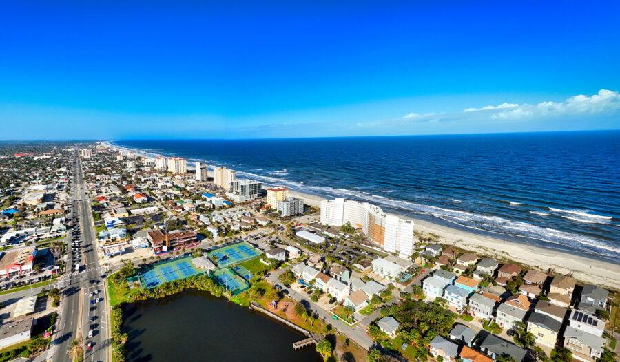 Aerial view of Jacksonville Beach, featuring a lively cityscape alongside the sparkling ocean.