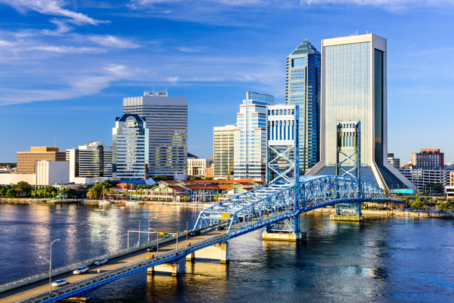 Jacksonville, Florida skyline featuring modern skyscrapers against a clear blue sky, reflecting the city's vibrant atmosphere.