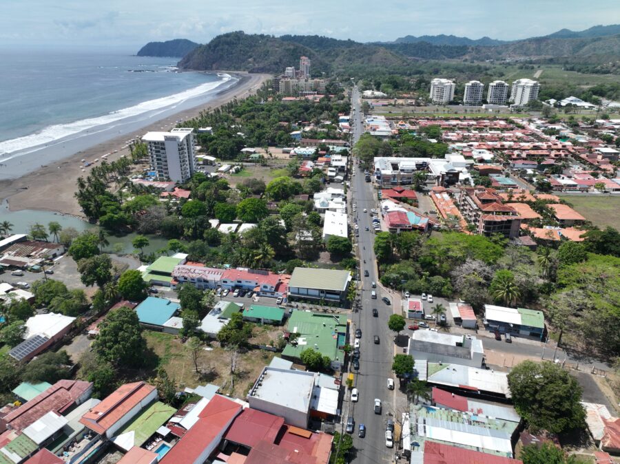 Aerial view of Jaco Beach, Costa Rica, showcasing the coastal city and traffic on the roads