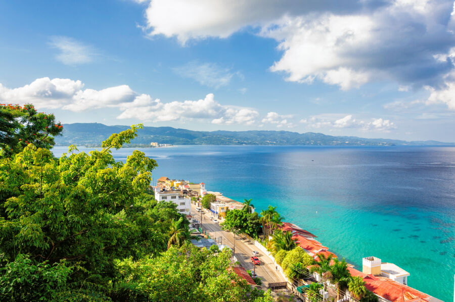 Scenic Montego Bay, Jamaica, featuring stunning beaches, turquoise waters, and lush greenery against a sunny backdrop