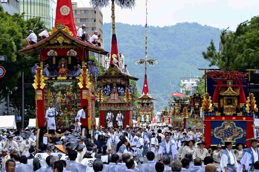 Vibrant Gion Matsuri parade with traditional floats and modern city backdrop.