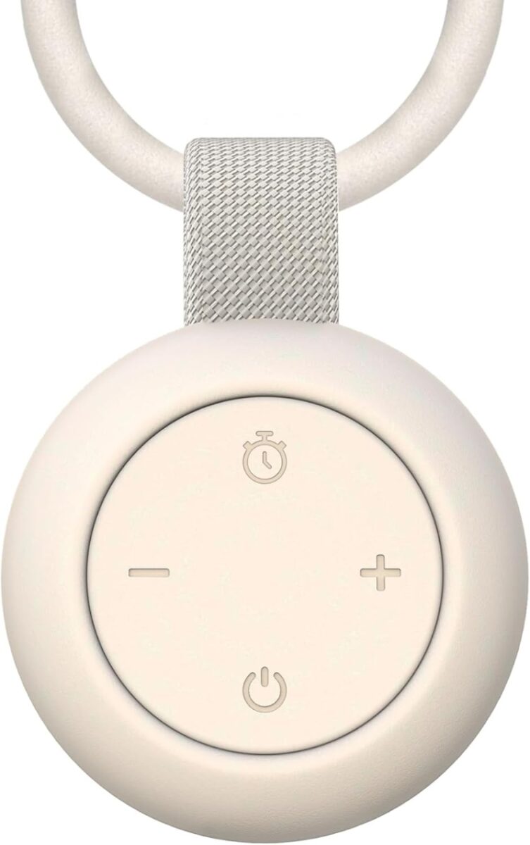Close-up of a white button on the Jaroco Portable Sound Machine, blending seamlessly with its white exterior.