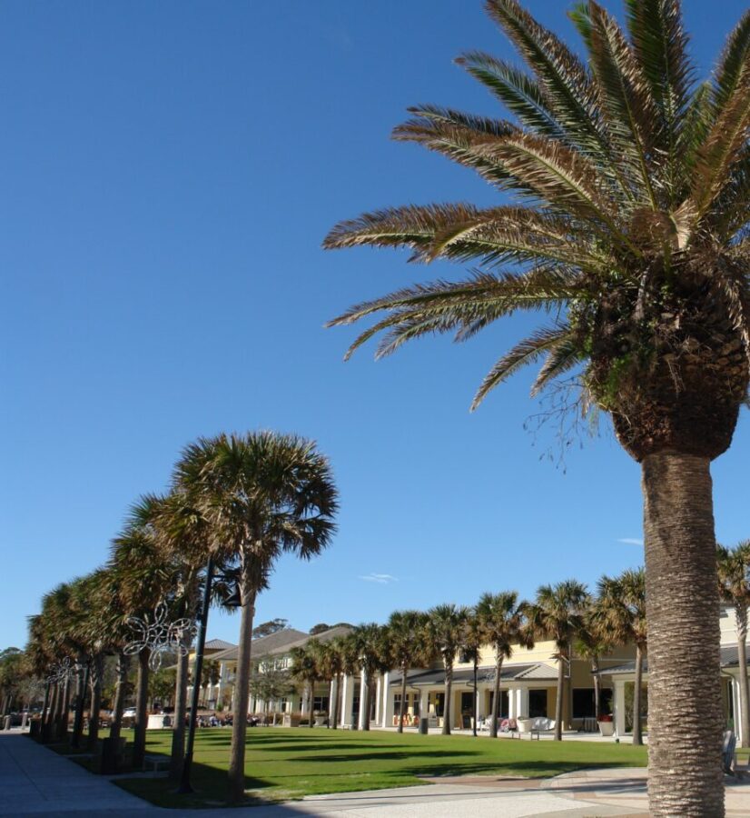 Jekyll Island Beach Village features charming cottages and sandy beaches under a clear blue sky, perfect for relaxation.
