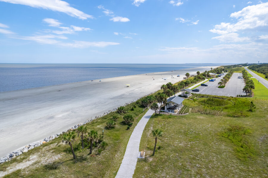 Bright blue sky over Jekyll Island's beach, showcasing a serene coastal scene with soft waves and golden sand.