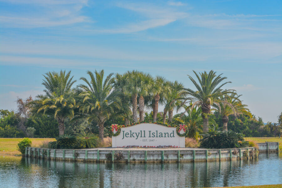 Jekyll Island sign welcoming visitors to the barrier island in Glynn County, Georgia, featuring natural surroundings