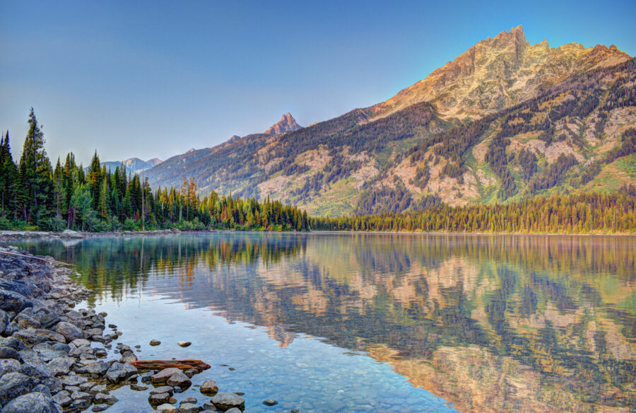 Scenic view of Jenny Lake surrounded by mountains at Grand Teton National Park in Moose, Wyoming