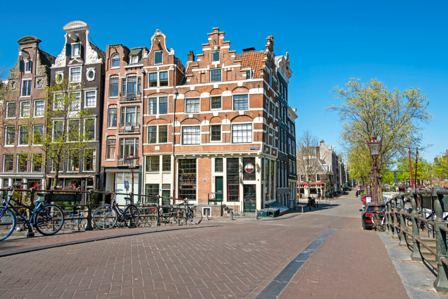 Historic medieval buildings along the canal in Amsterdam's Jordaan district reflect the area's rich architectural heritage.