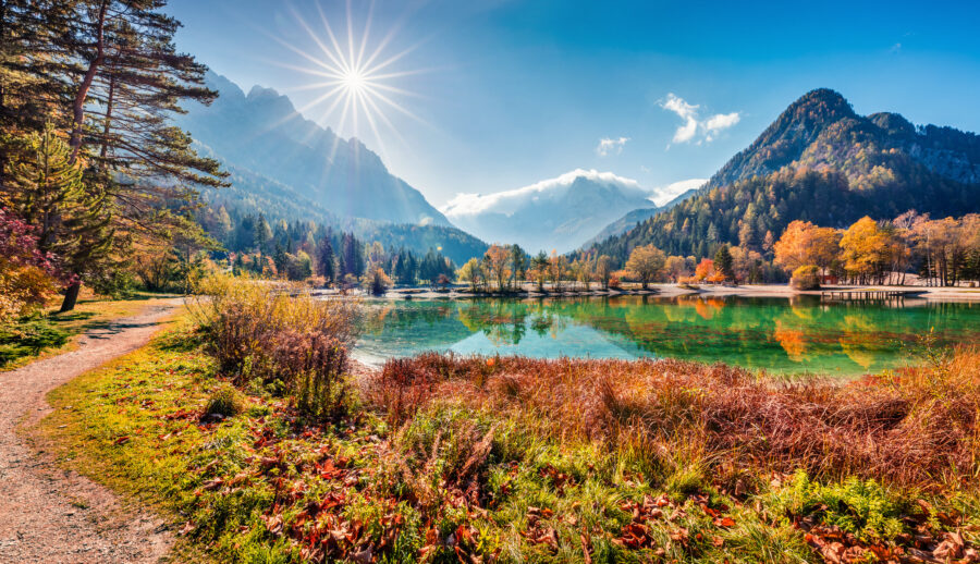 Sunny morning view of Jasna Lake with autumn colors in the Julian Alps, Triglav National Park, Slovenia.