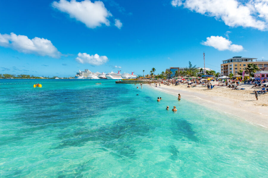 Scenic view of Junkanoo Beach, showcasing the sandy shore and Nassau cruise port in the Bahamas under a clear blue sky.