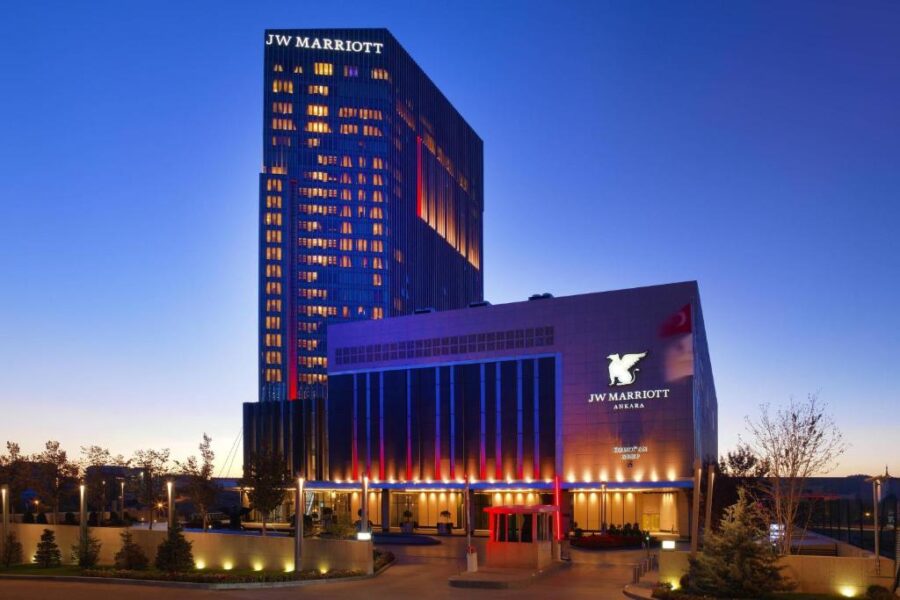JW Marriott Hotel Ankara illuminated at night, showcasing its elegant architecture against the dark sky.