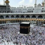 Panoramic view of Kaaba in Masjid al-Haram, Mecca, during Tawaf with pilgrims.