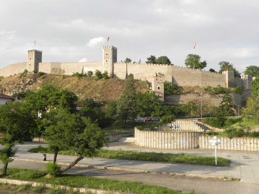Kale Fortress sits atop a hill surrounded by trees and buildings in Skopje, Macedonia.