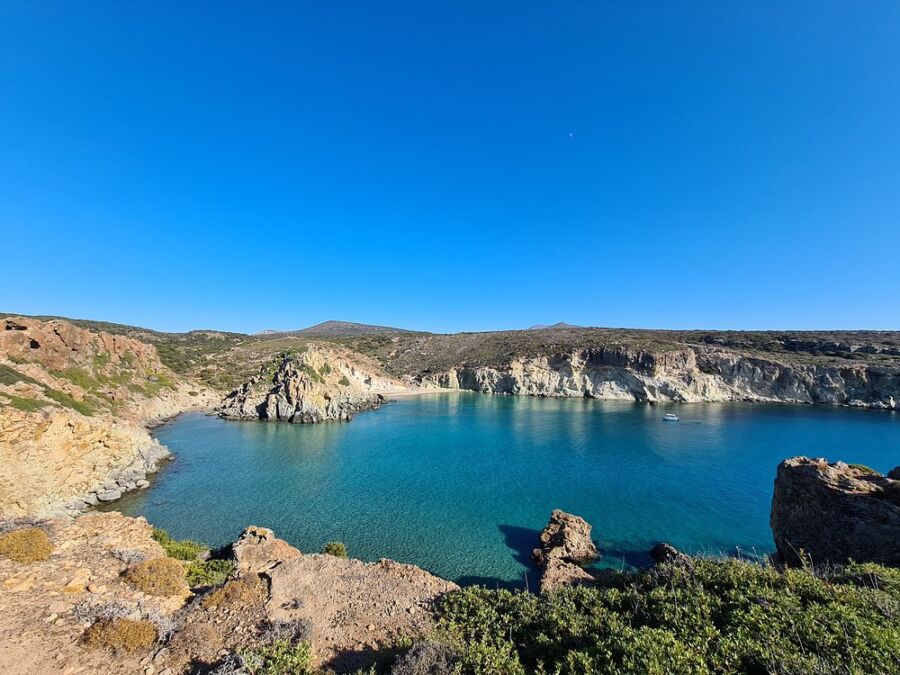The serene blue waters of Kalogries Beach in the Bay of Kos, surrounded by soft sandy shores and gentle waves.

