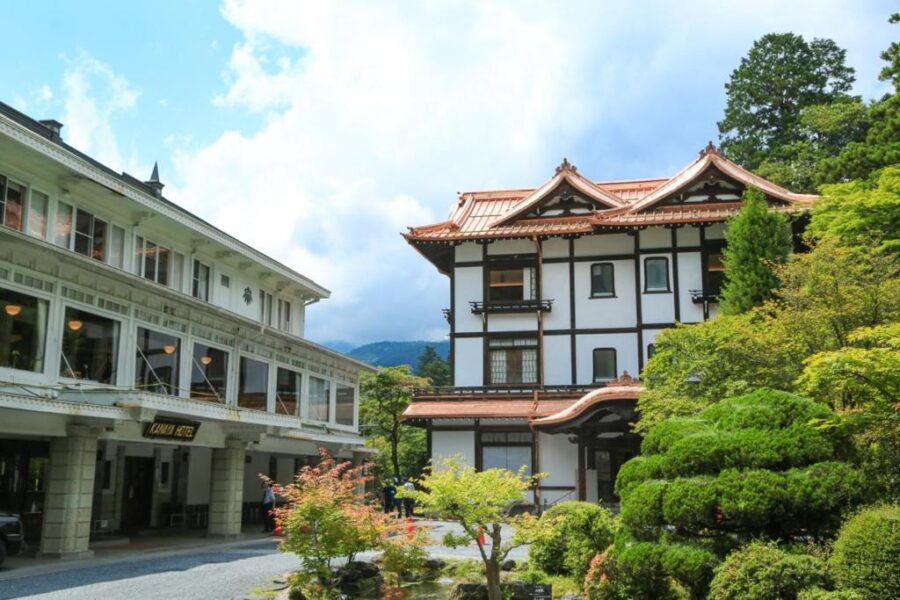 Nikko Kanaya Hotel traditional Japanese architecture surrounded by lush garden and mountain retreat landscape.