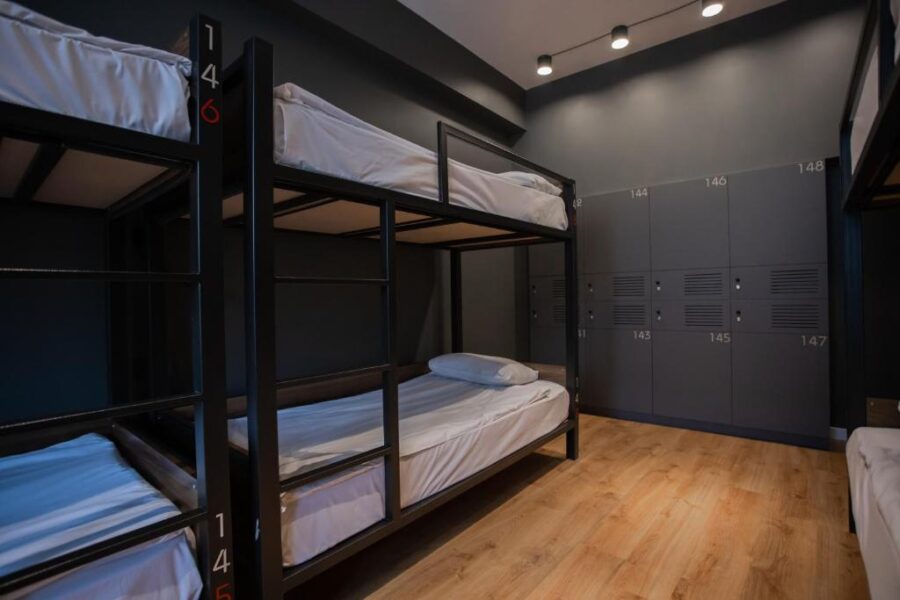 Interior of Kantar Hostel in Yerevan, Armenia, showcasing a bunk bed room with two beds and storage lockers.
