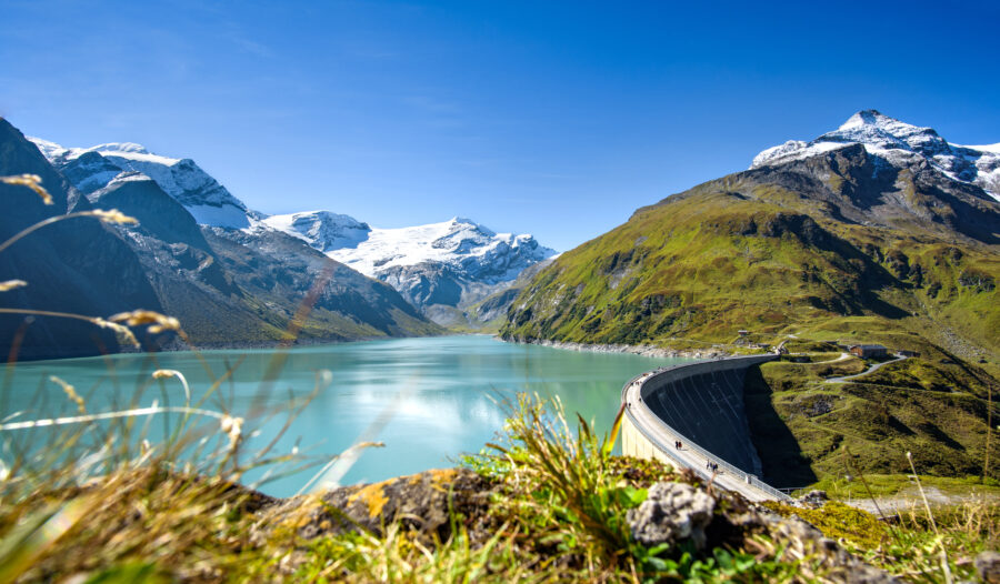 Panoramic landscape of Kaprun Hochgebirgsstauseen, featuring vibrant blue lakes and towering peaks in Austria
