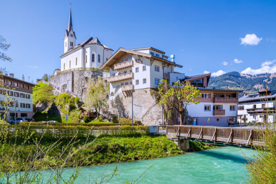 Summer view of Kaprun village in Salzburg, Austria, featuring lush greenery and picturesque alpine scenery