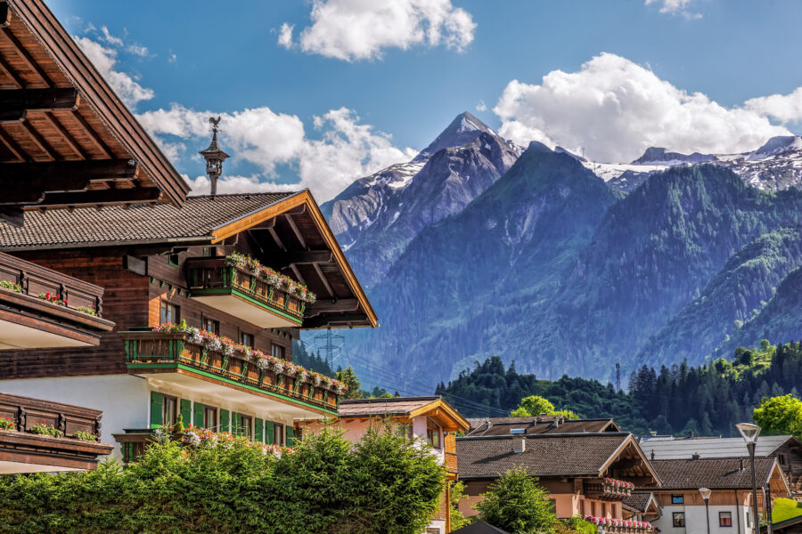 Scenic view of Kaprun village featuring a typical pension, with the Kitzsteinhorn glacier in the backdrop, Austrian Alps