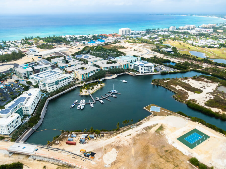 Scenery of the yacht harbor and the business district of George Town, Grand Cayman, with modern buildings and a tropical atmosphere.