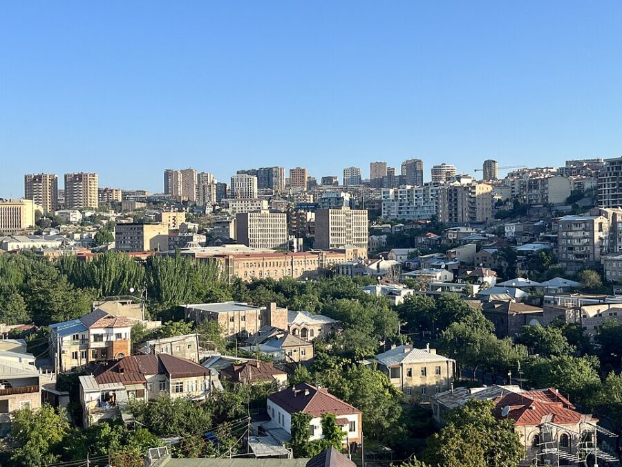 Panoramic view of Kentron Yerevan, Armenia, showcasing numerous buildings and trees in the background.