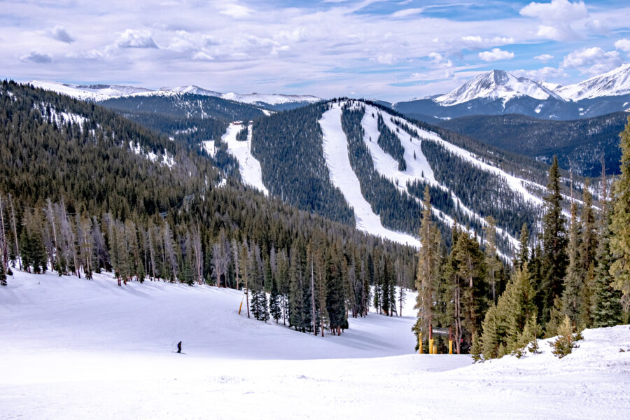 Scenic view of Keystone Ski Resort town, showcasing snowy mountains, cozy lodges, and skiers enjoying the slopes