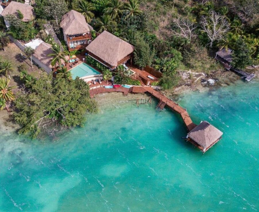 Aerial view of Khaban Bacalar Hotel Boutique, showcasing a beach house and dock in Bacalar, Quintana Roo, Mexico.