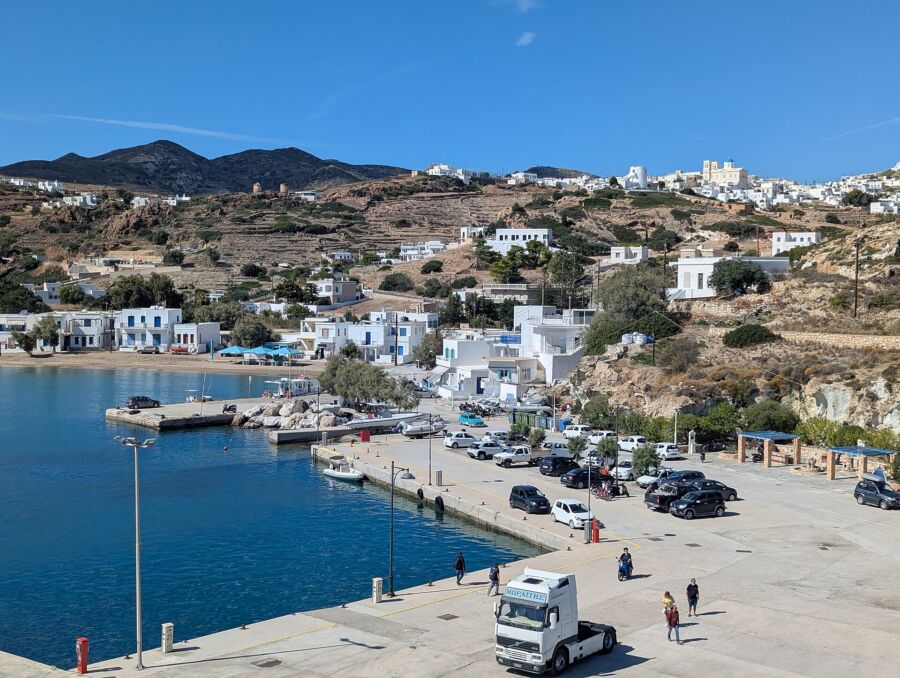 Scenic view of the harbor and town of Kalymnos, Greece, showcasing colorful buildings and boats on the water.