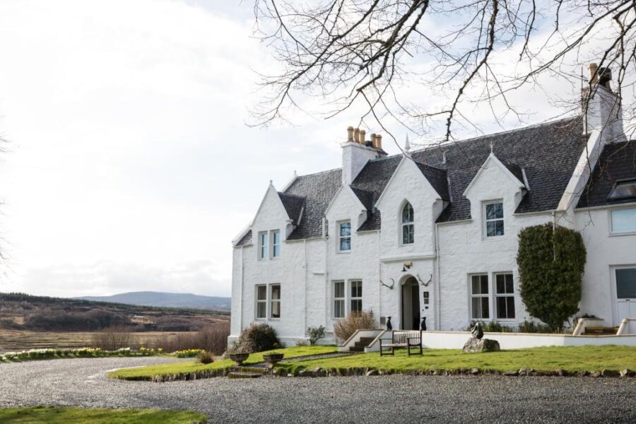 Kinloch Lodge Hotel and Restaurant, featuring a white house with a driveway approaching the entrance.