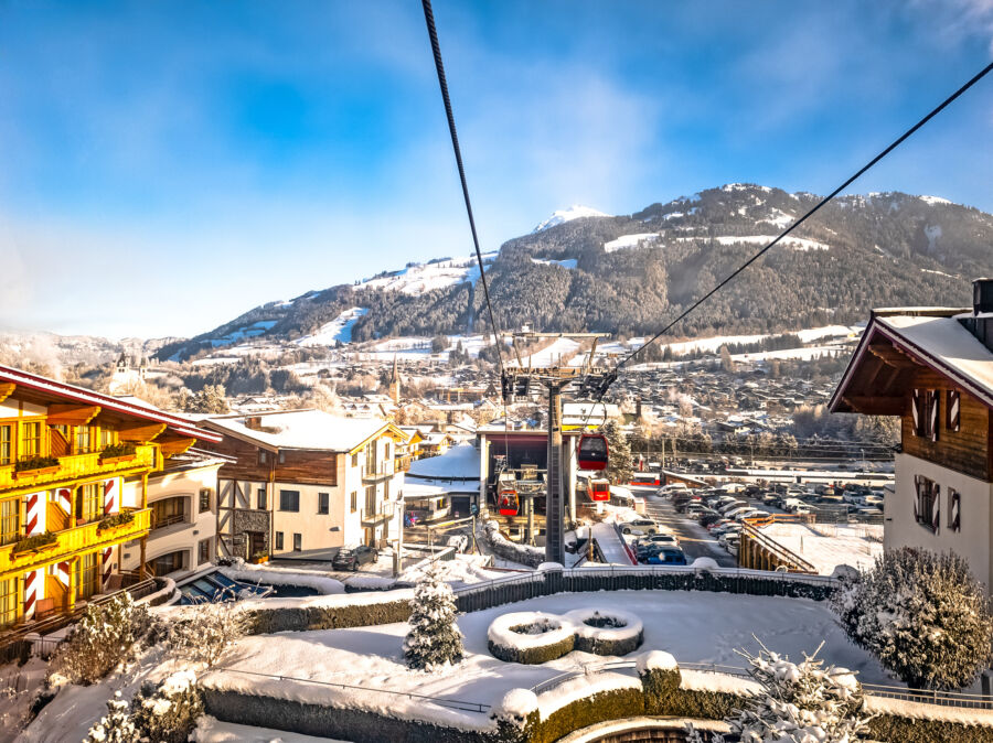 Scenic view of Kitzbuhel ski resort nestled in the Austrian Alps, showcasing snow-covered slopes and charming alpine architecture