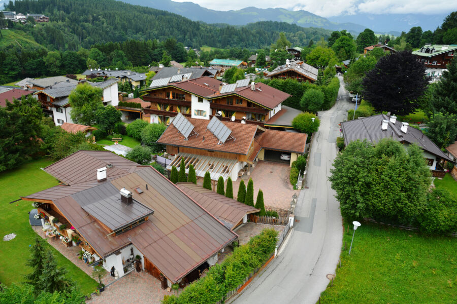 Aerial view of Kitzbuhel town and ski resort, showcasing its architecture amidst the scenic Austrian Alps in Tirol