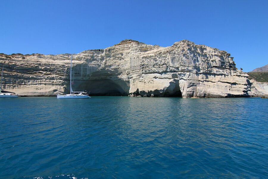 Majestic rock formation at Kleftiko, Milos, Greece, surrounded by clear blue waters and dramatic cliffs.