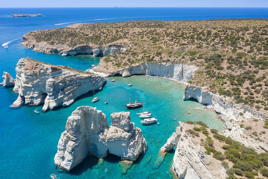 Aerial view of Kleftiko, Milos Island, showcasing stunning blue waters and dramatic cliffs.
