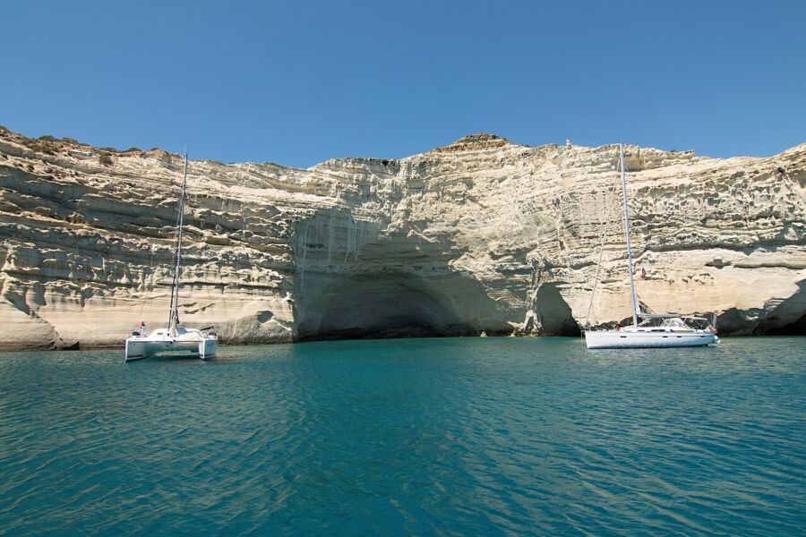 Expansive blue sky at Kleftiko, Milos, creating a tranquil atmosphere for the surrounding yachts.

