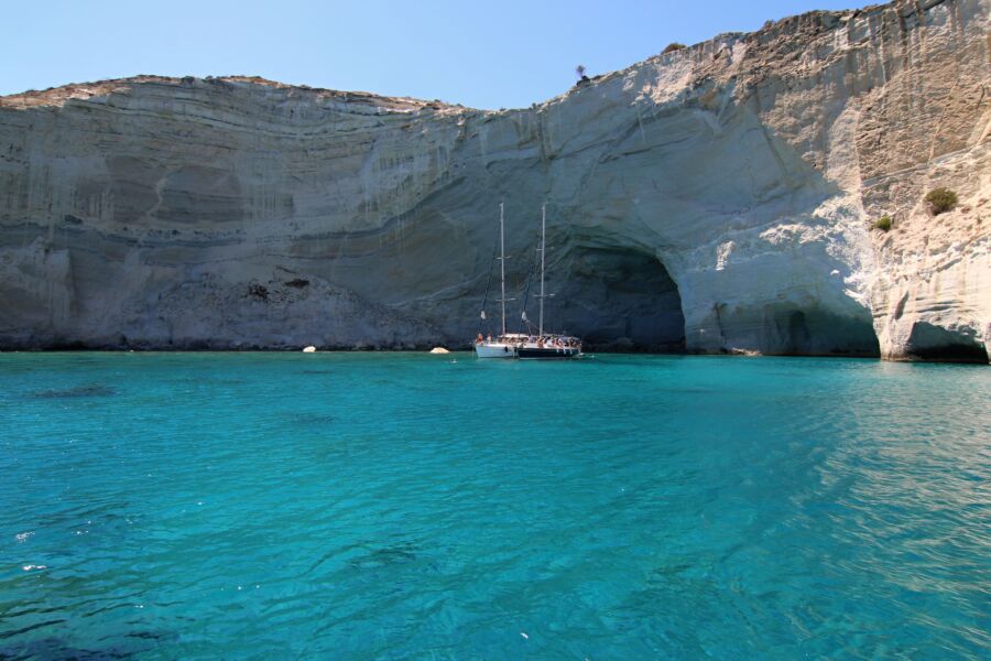 Scenic view of Kleftiko, Milos Island, Greece, featuring white rock formations and turquoise waters under a clear sky.
