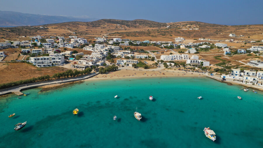 Aerial view of Ammos beach and Koufonisi port, showcasing sandy shores and turquoise waters in the Small Cyclades, Greece.