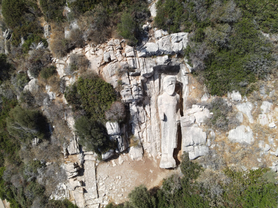 Aerial view of the Kouros statue in Apollonas, Naxos Island, Greece, showcasing the statue with surrounding landscape